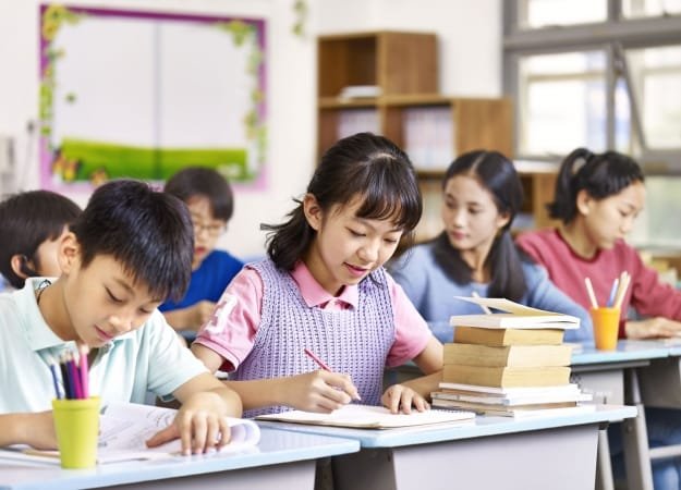 Young English learners working together in a classroom