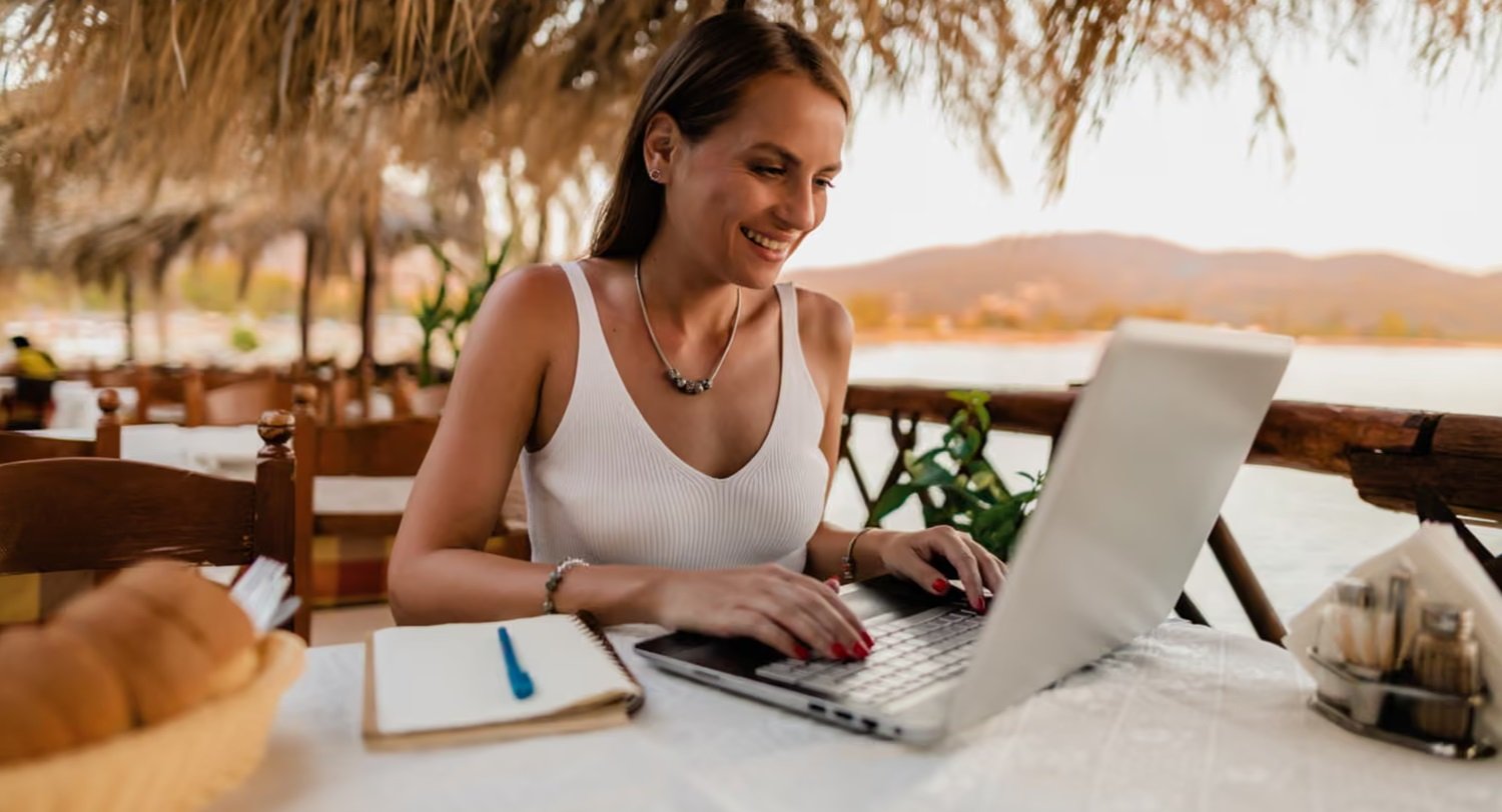 Woman using a laptop at the beach